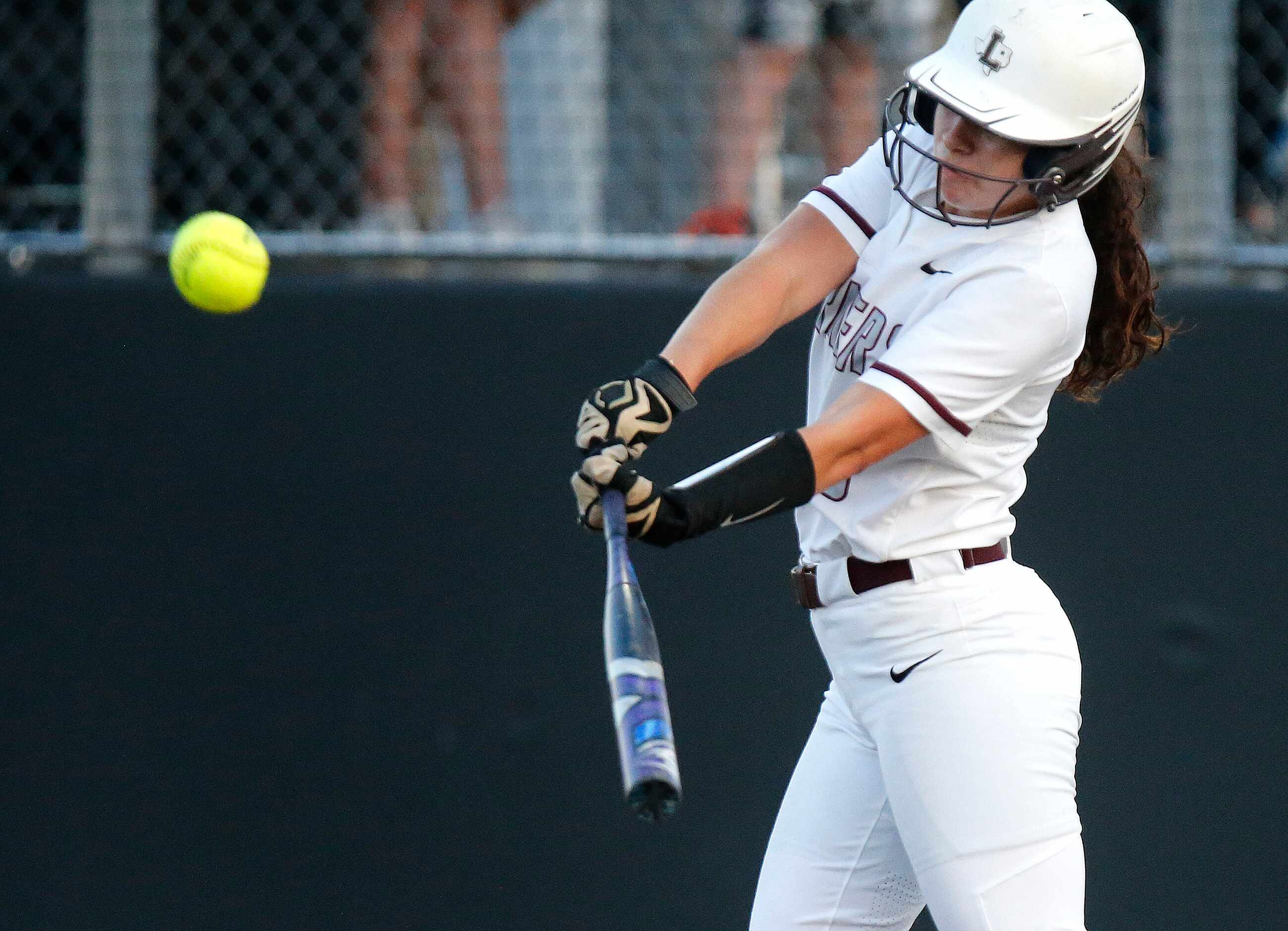 Lewisville High School left fielder Rylee Brice (8) hits a home run in the first inning as...