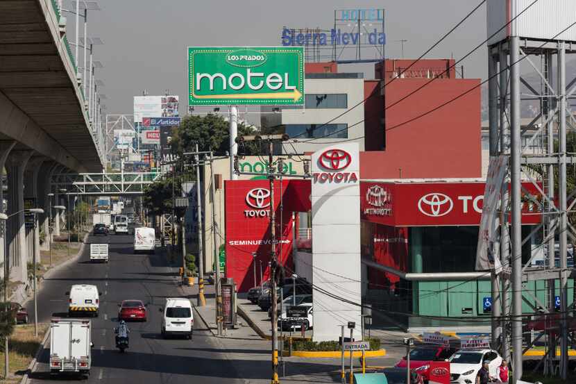 Vehicles pass in front of a Toyota Motor Corp. car dealership in Mexico City, Mexico, on...