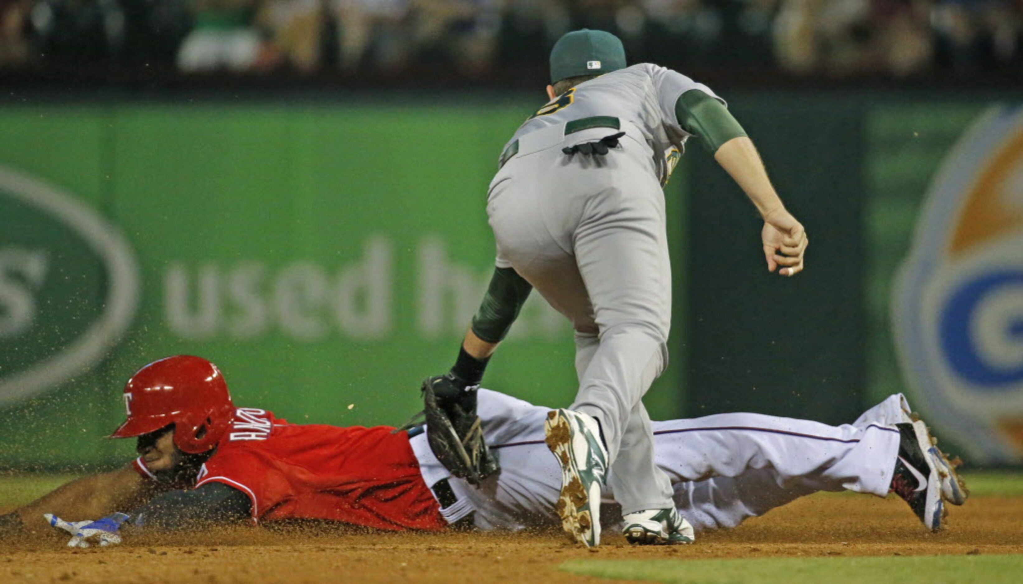 Texas' Elvis Andrus is tagged out at second on an attempted steal as Oakland's Jed Lowrie...