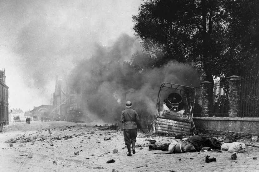 Smoke and debris in a street of Dunkirk, France, showing the effects of bombardment, June...