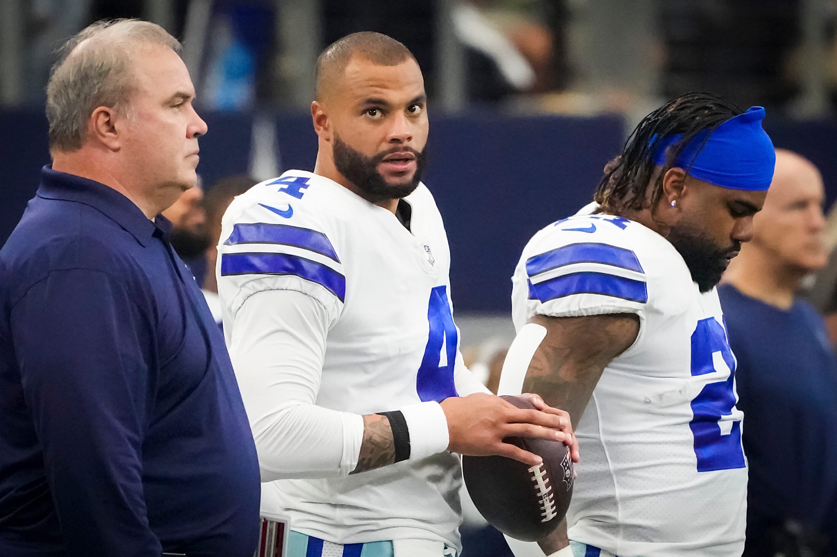 Dallas Cowboys quarterback Dak Prescott (center) stands with head coach Mike McCarthy and...