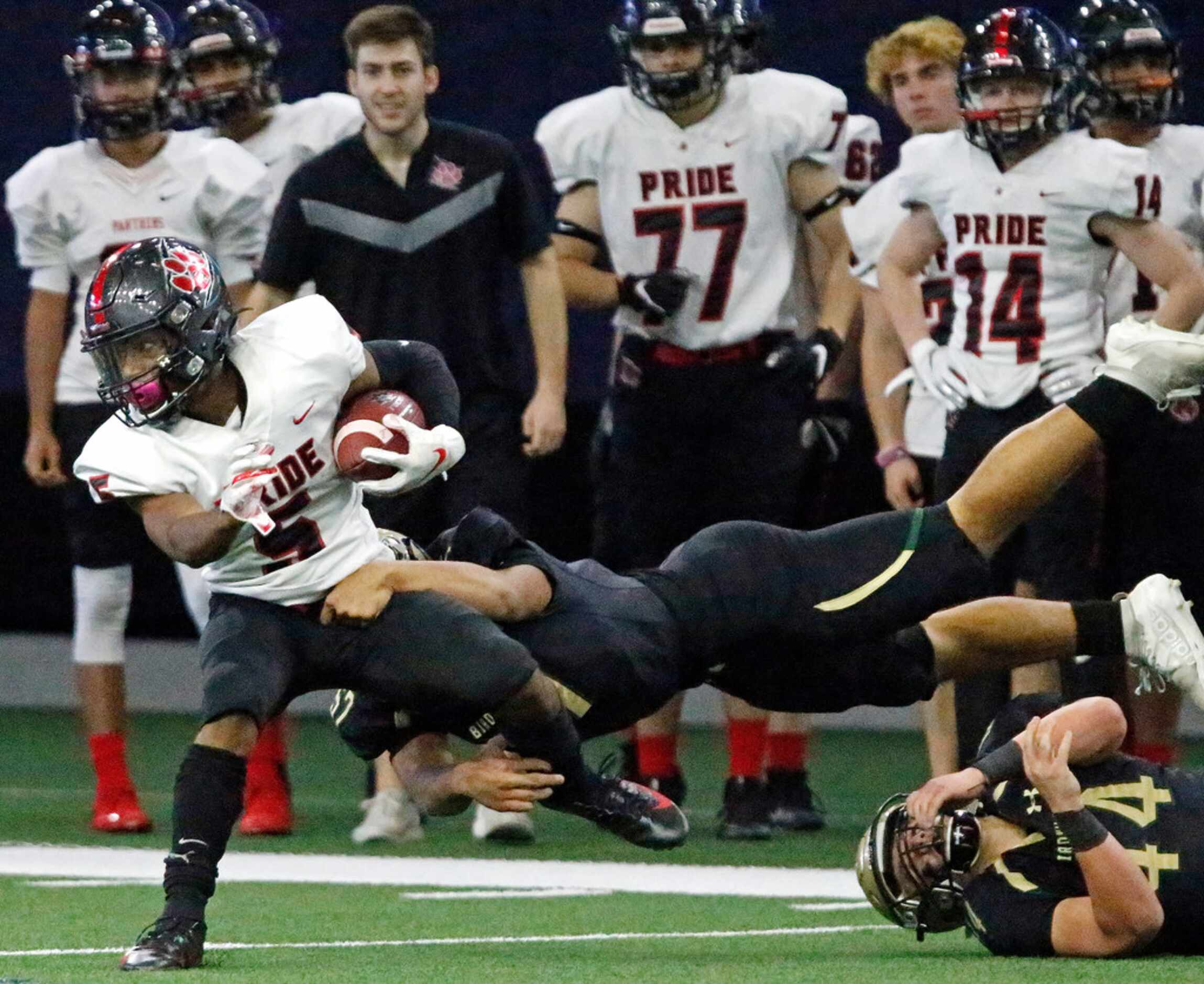 Birdville High School outside linebacker John Nguyen (57) make a diving tackle on...