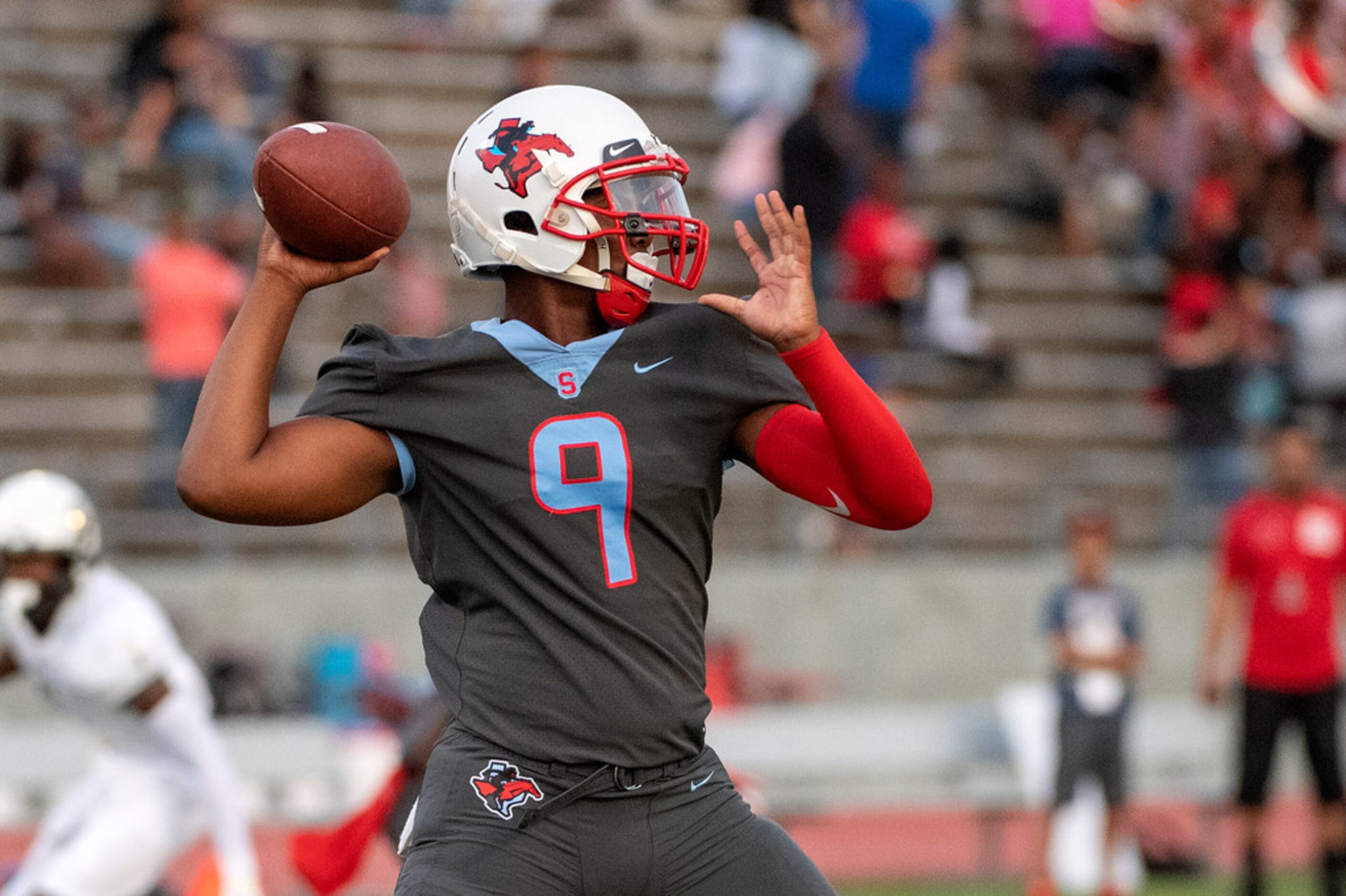 The Southeast Dallas Wolverines youth football team takes the field along with South Oak...