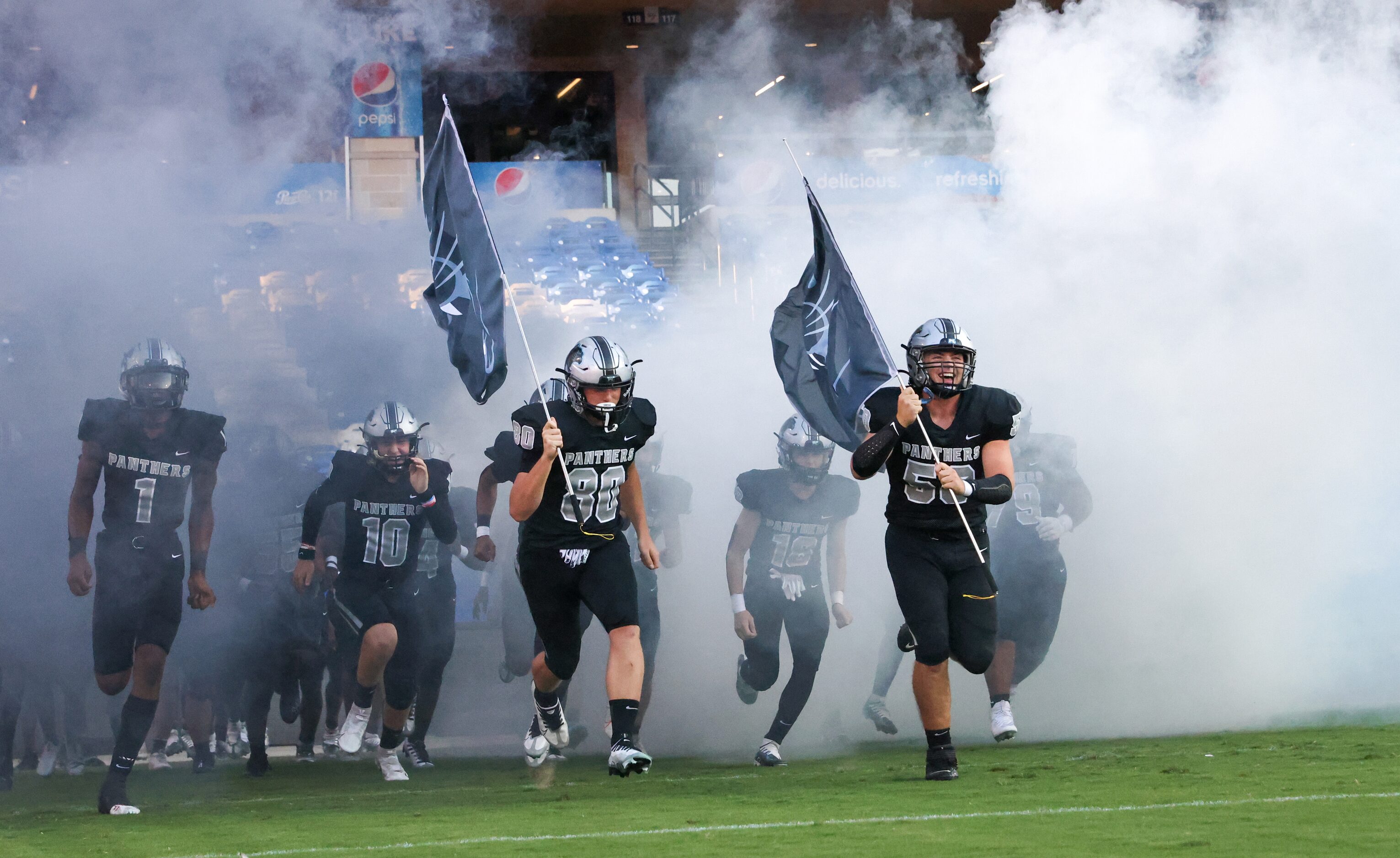 The Panther Creek Panthers enter the field to play the Emerson Mavericks on Friday, Sept. 9,...