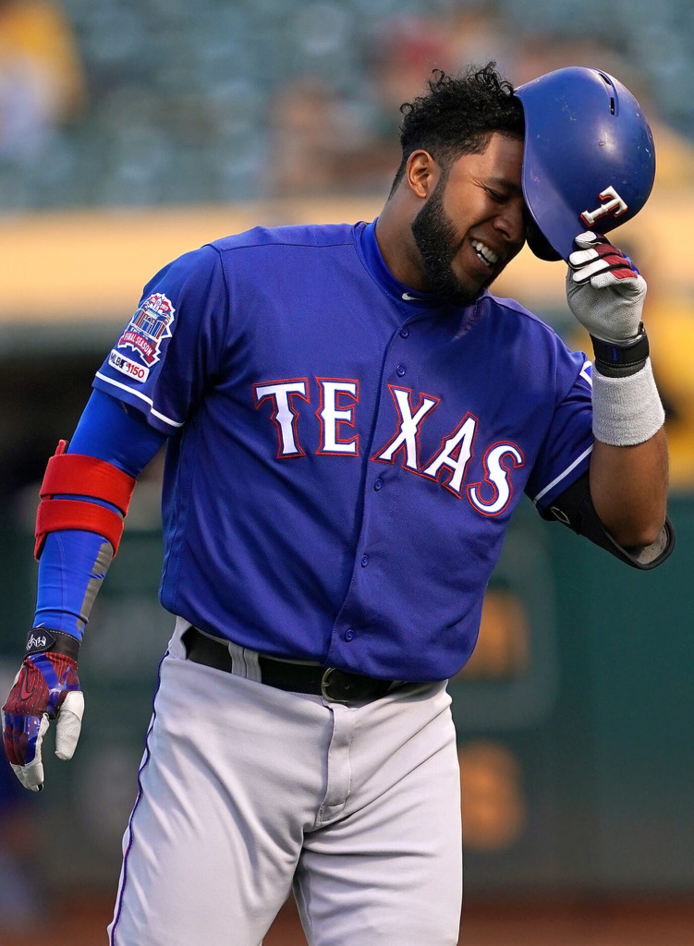 OAKLAND, CA - APRIL 22:  Elvis Andrus #1 of the Texas Rangers reacts in pain after he was...