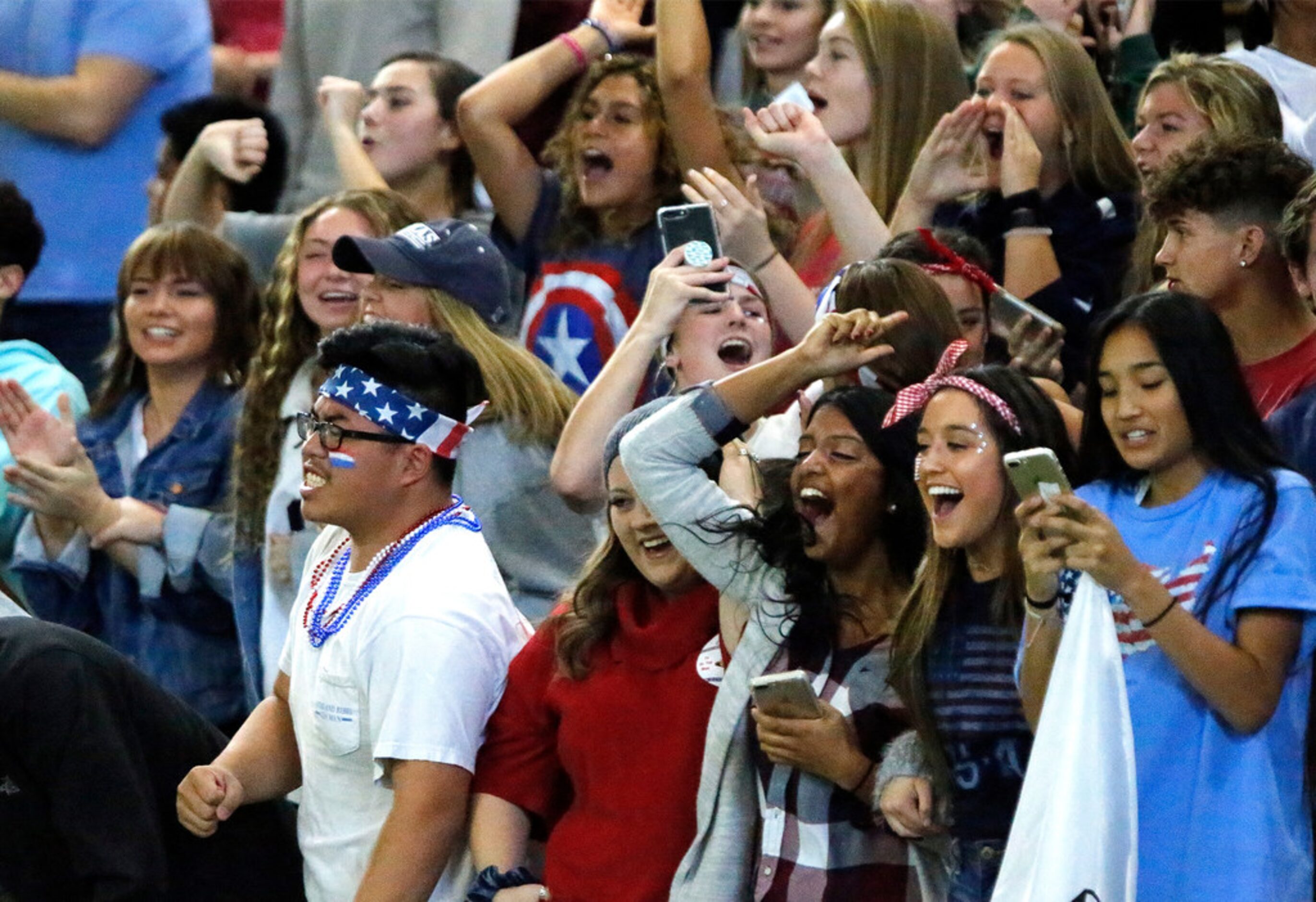 The Richland High Shcool student section reacts to the first score of the game during the...