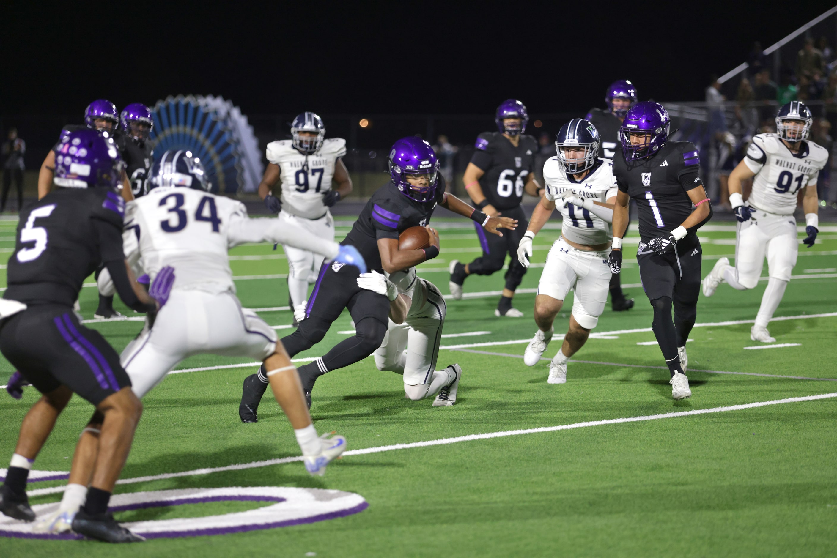 Anna player #8 Ziondre Williams breaks a tackle during the Prosper Walnut Grove High School...