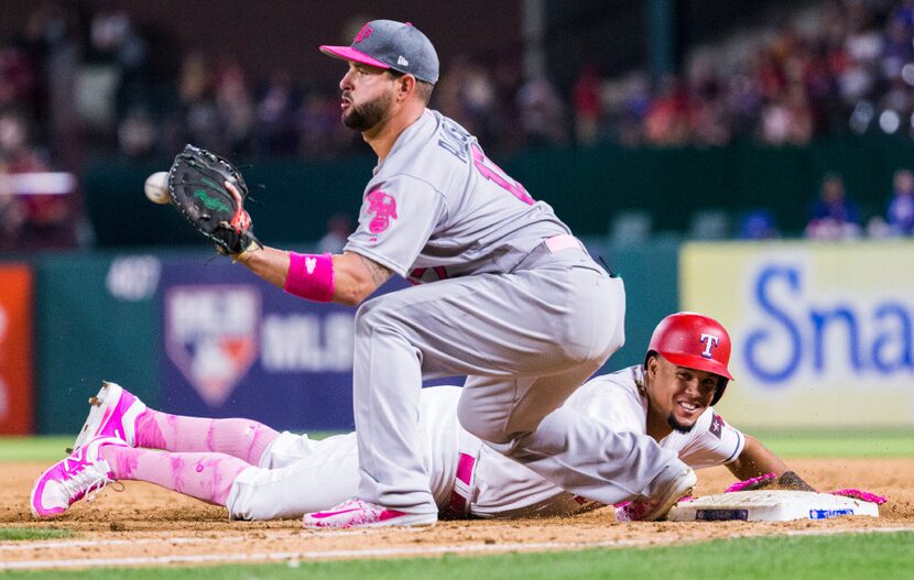 Texas Rangers center fielder Carlos Gomez (14) makes it back to first base as Oakland...