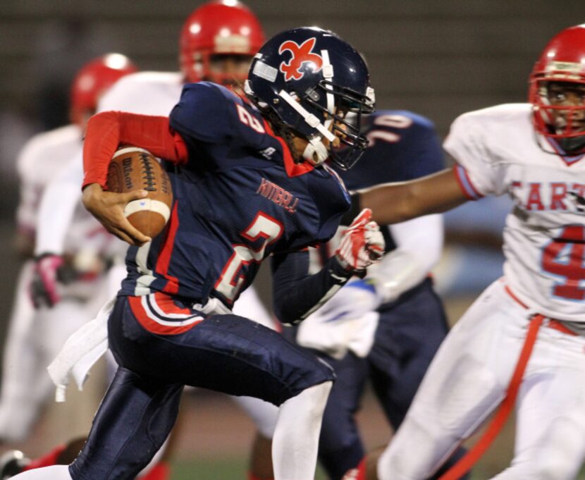 Kimball quarterback Traveon Thibodeaux (2) bolts into the Carter defense during a first...