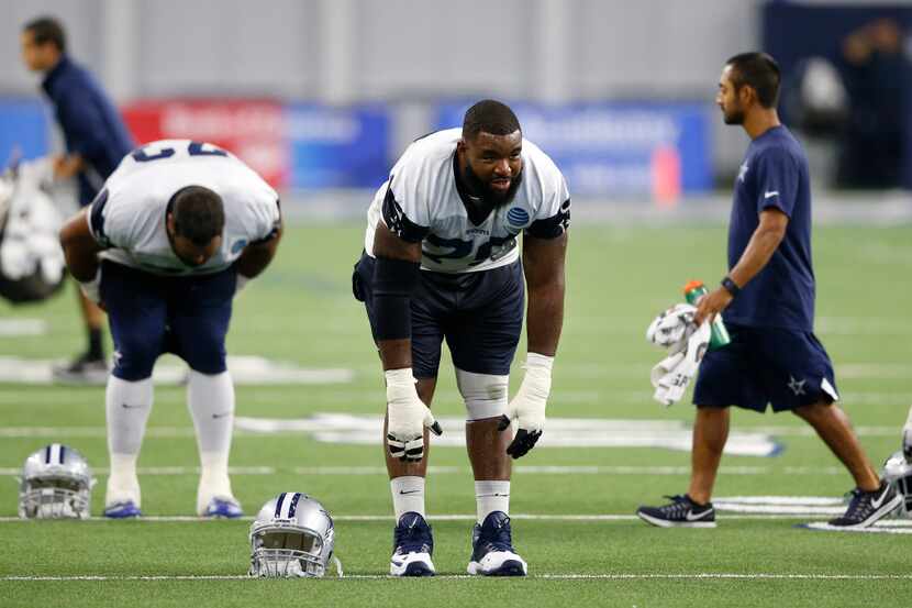 FILE - Dallas Cowboys offensive tackle Chaz Green (79) stretches at the end of a training...