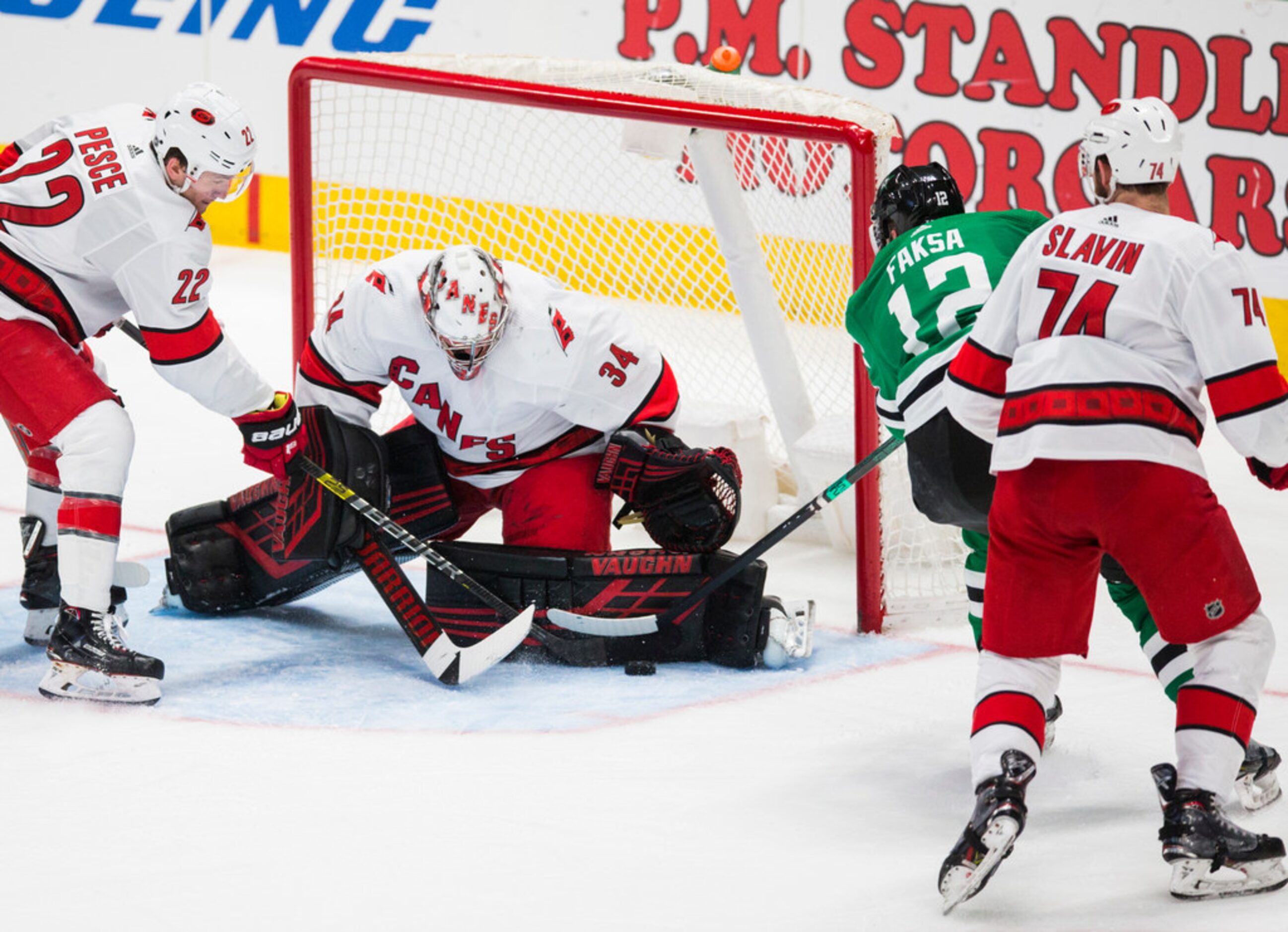 Dallas Stars center Radek Faksa (12) takes a shot at the goal, which is blocked by Carolina...