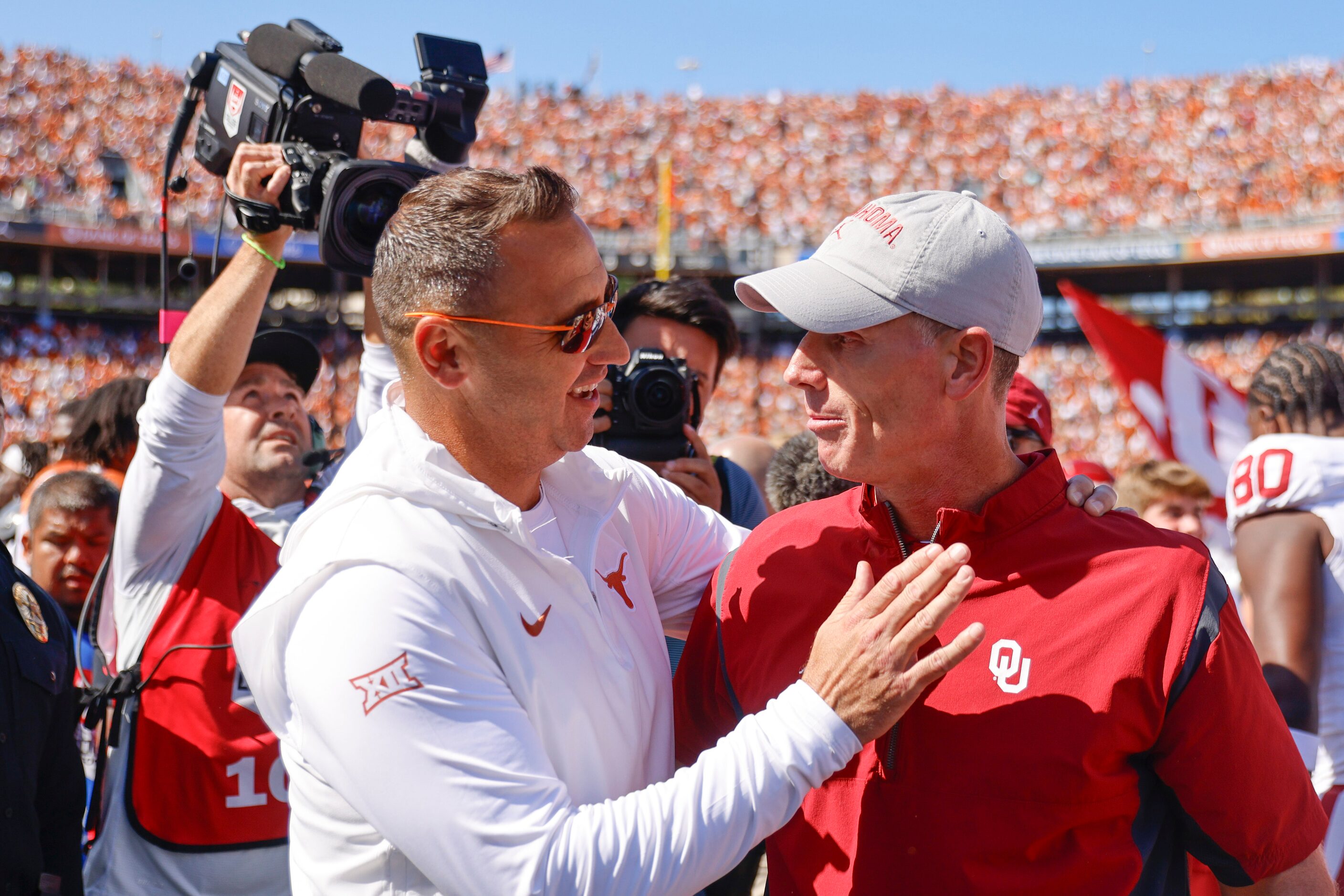 Texas head coach Steve Sarkisian (left) congratulates Oklahoma coach Brent Venables after...