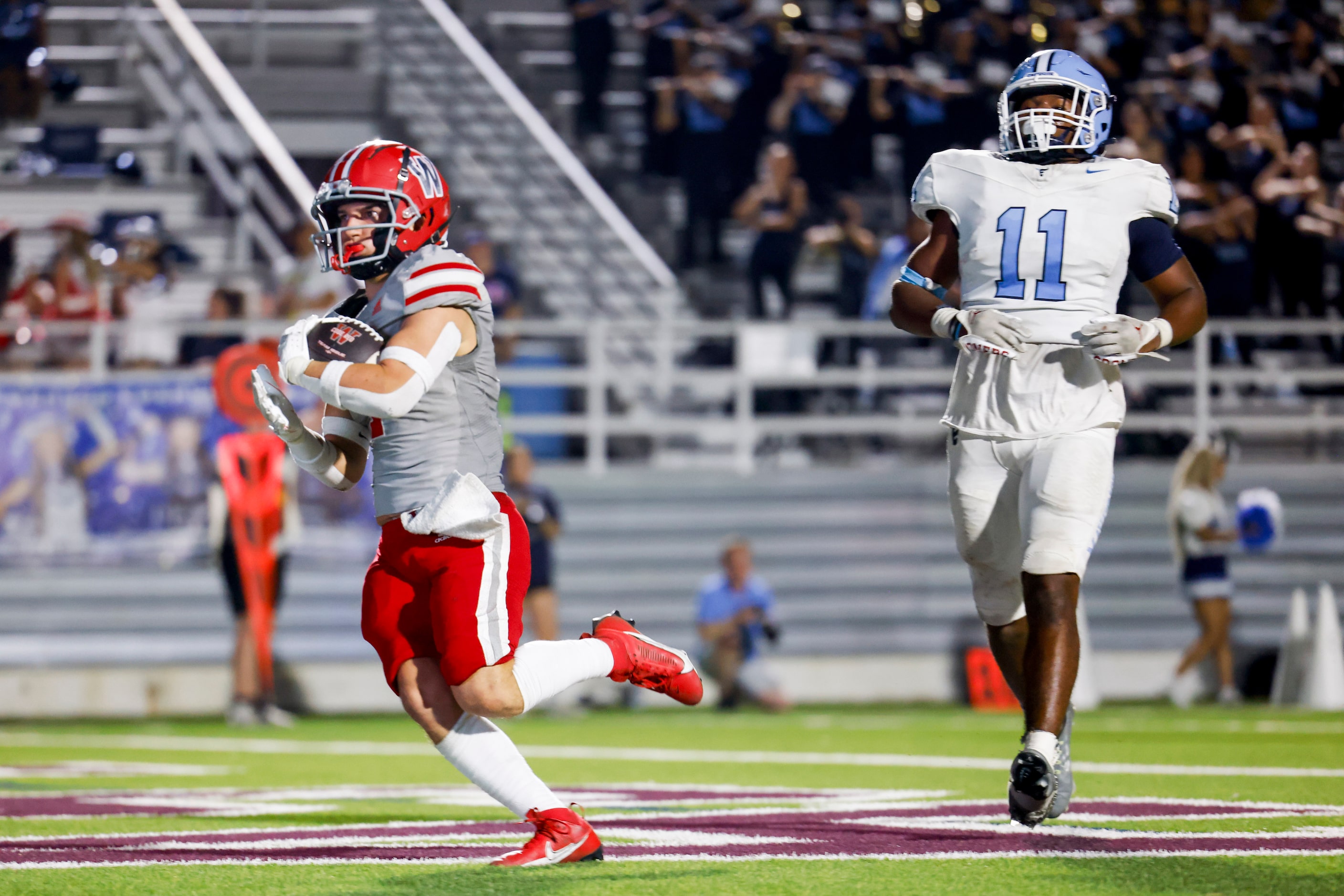 Woodrow Wilson’s Jacob Crissey (left) scores a touchdown past Emerson high’s Agape Lawrence...