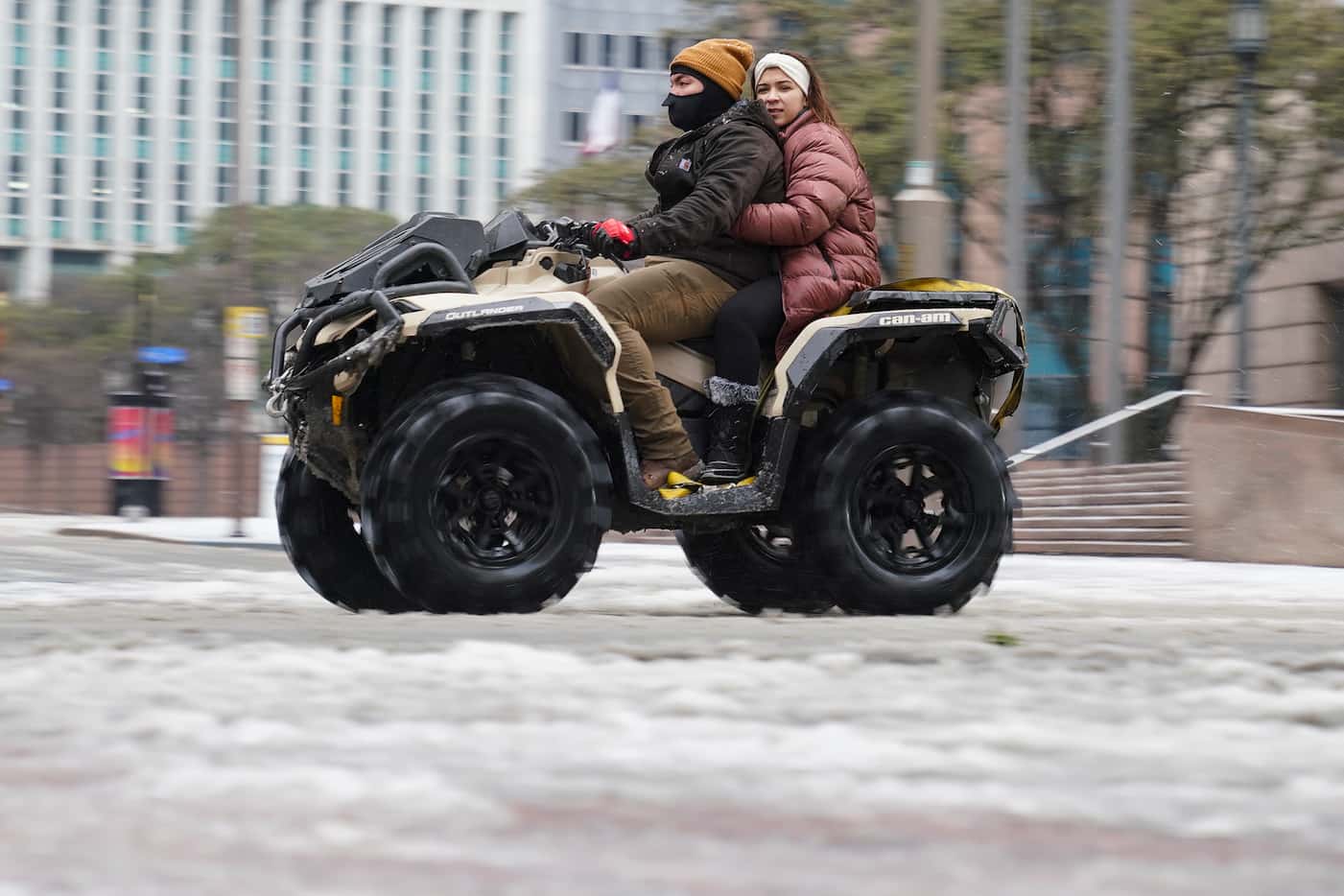 A person drives a four wheeler with other motorist through downtown, Wednesday, Feb. 1,...