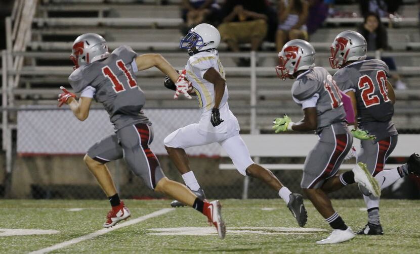 TXHSFB Conrad senior wide receiver Antonio Bivins (80) carries a pass for 40 yards as the...