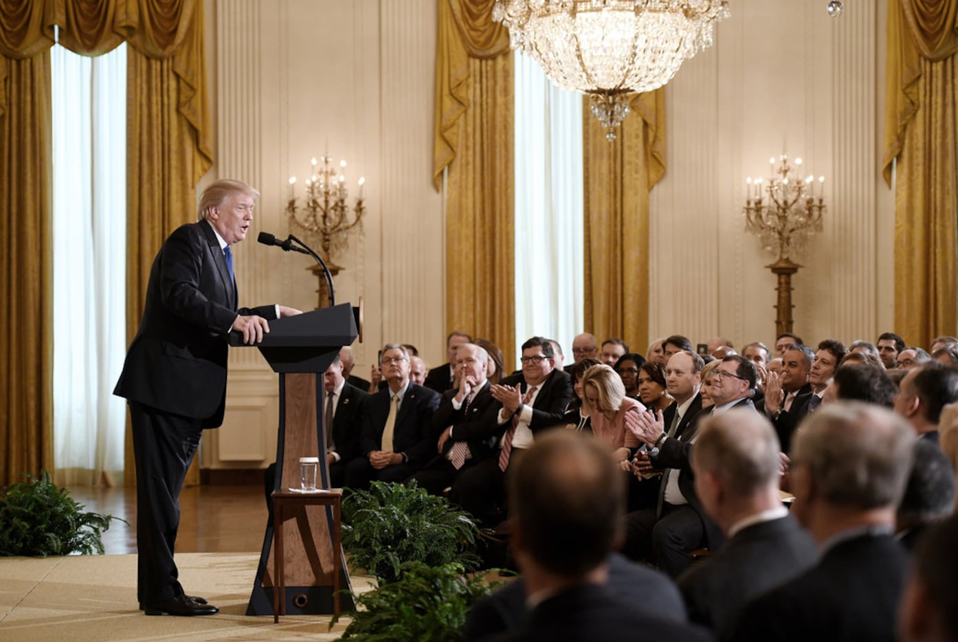President Donald Trump addresses mayors during a working session in the East Room of the...