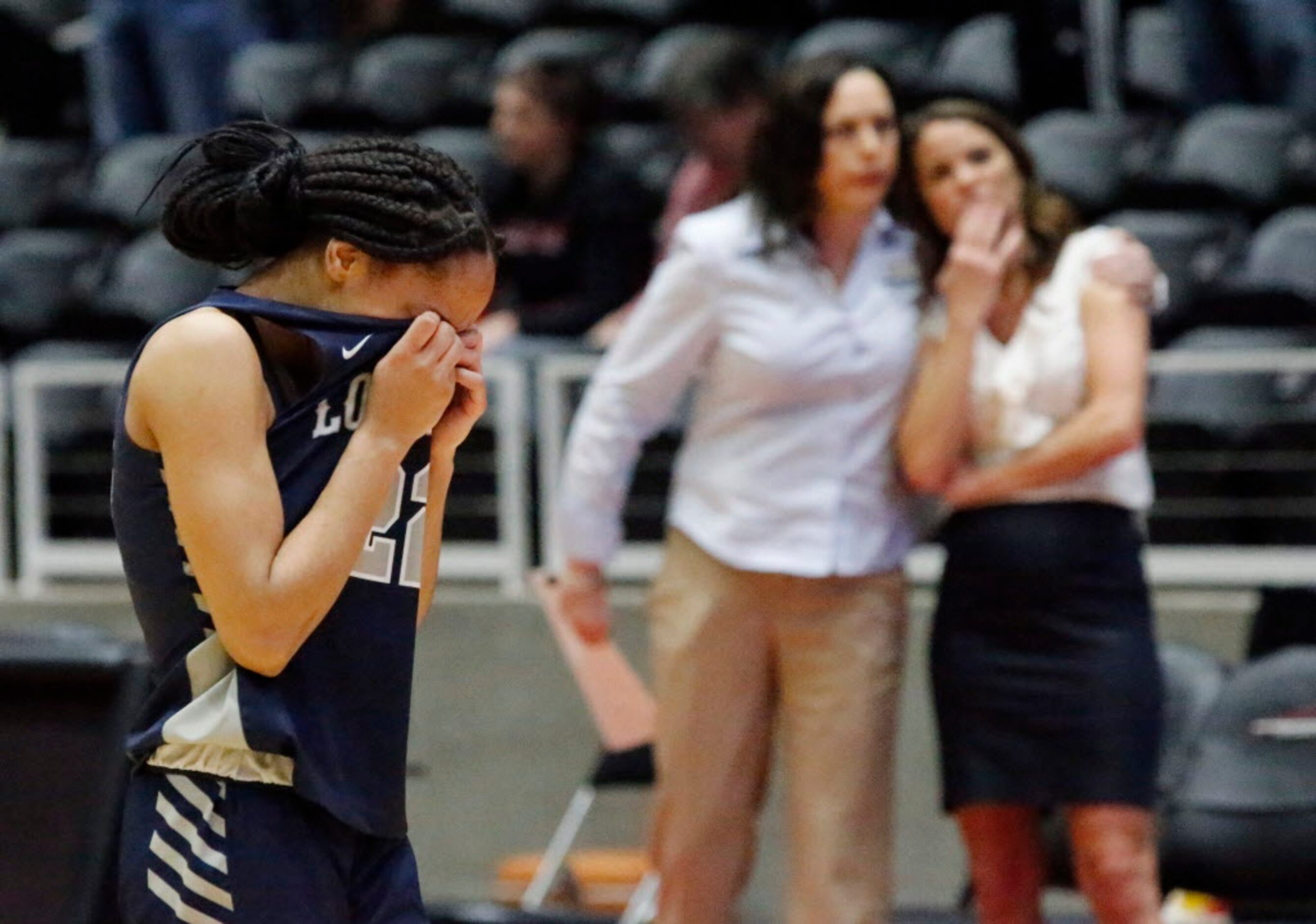 Lone Star High School guard Mia Deck (22) buries her face in her jersey after Lone Star High...