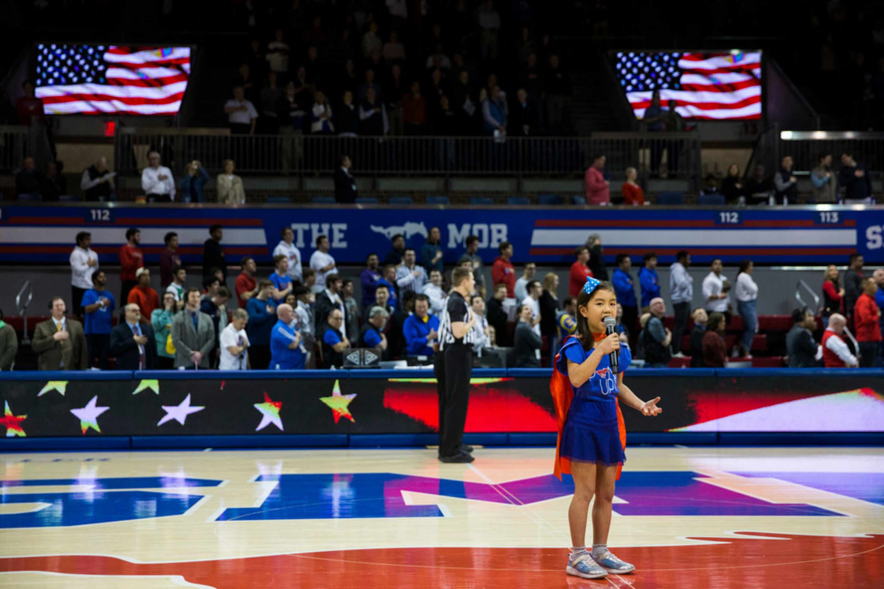 Lila Tran sings the national anthem before a basketball game between SMU and University of...