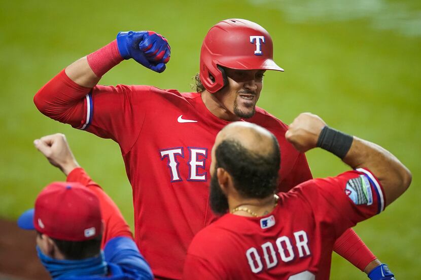 Texas Rangers first baseman Ronald Guzman celebrates with second baseman Rougned Odor after...