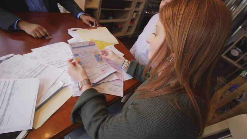 Marlena Wilzbach goes over medical bills with an NBC5 consumer reporter.