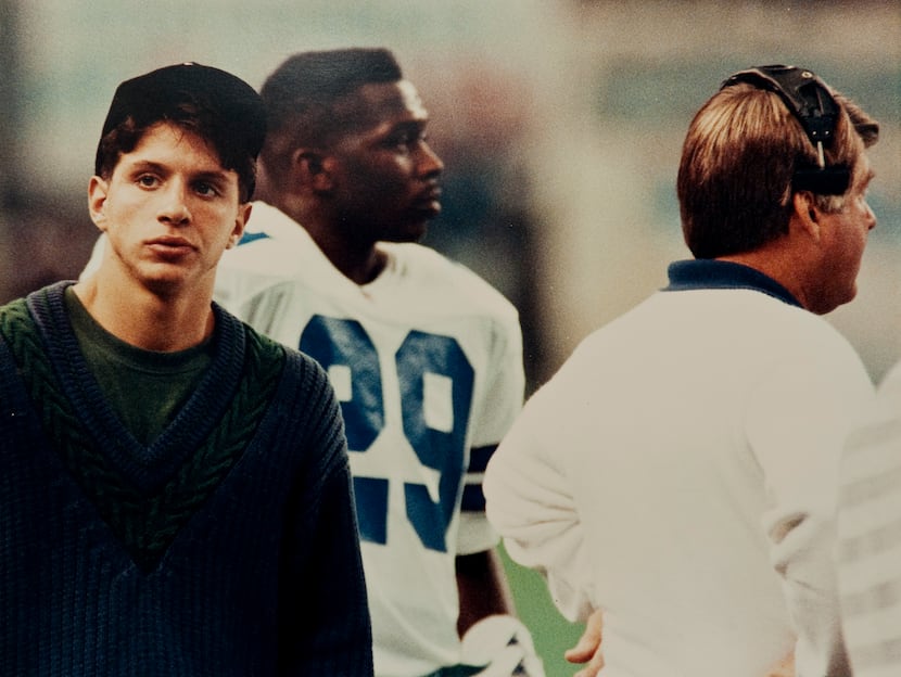 A copy photograph of Damon West (left) standing on the sidelines with the Dallas Cowboys'...