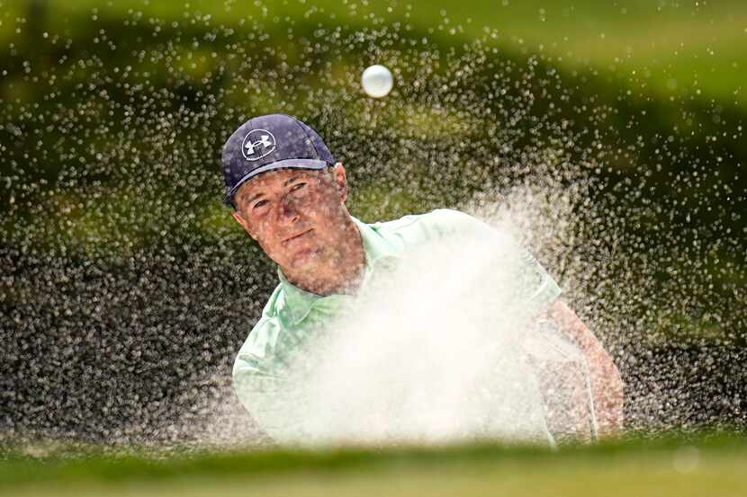 Jordan Spieth blasts out of a bunker on the eighth hole during the second round of the Texas...