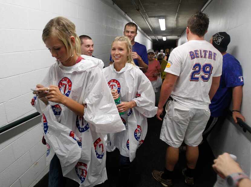Texas Rangers fans wait out a storm Tuesday night in a tunnel underneath Rangers Ballpark in...