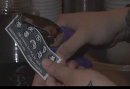 Black Forge co-owner Ashley Corts punches a hole in a sample card.