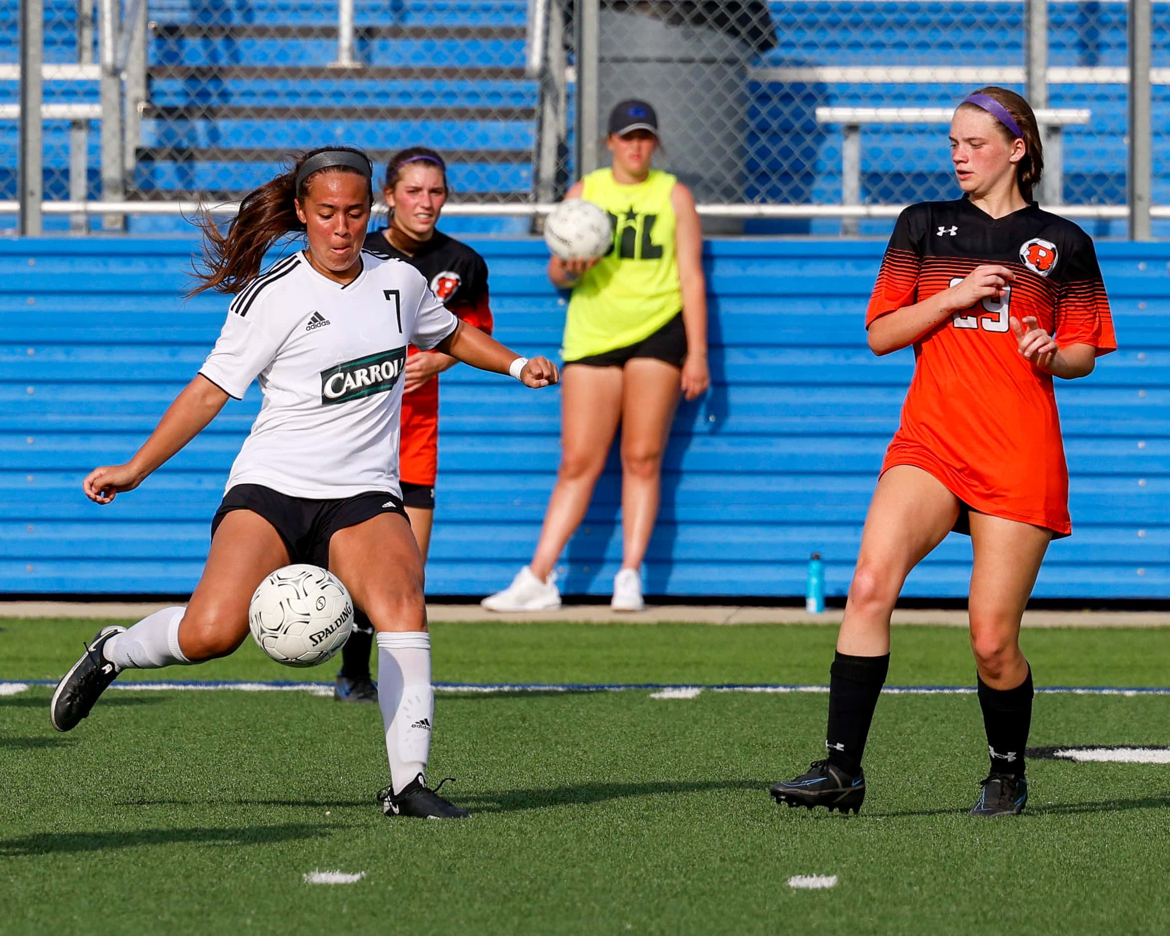 Southlake Carroll midfielder Bella Clahane (7) passes the ball in front of Rockwall defender...