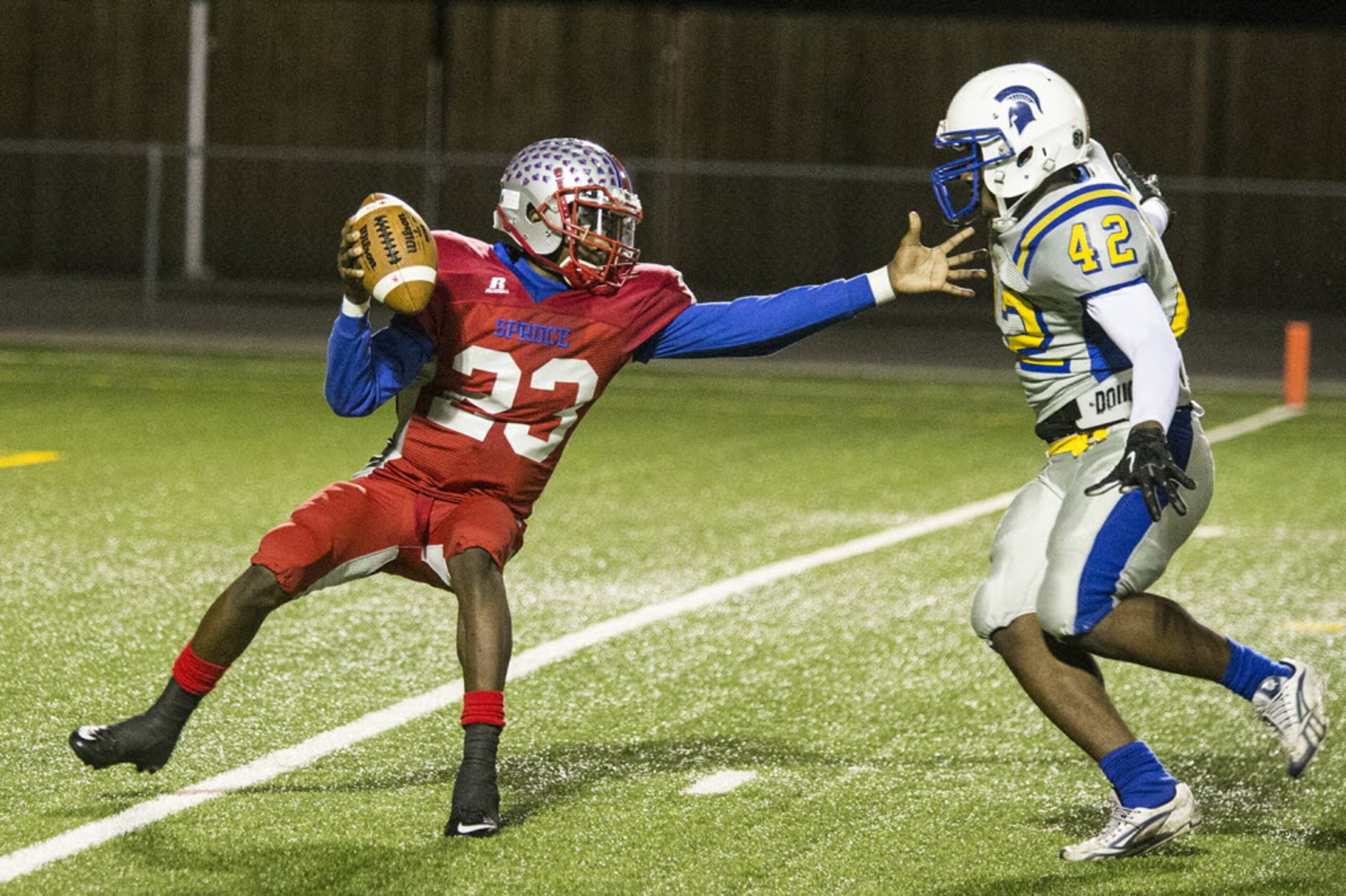 Spruce's Travion Hardman (23) attempts to evade Samuell's Adrian Luckey (42) during W. W....