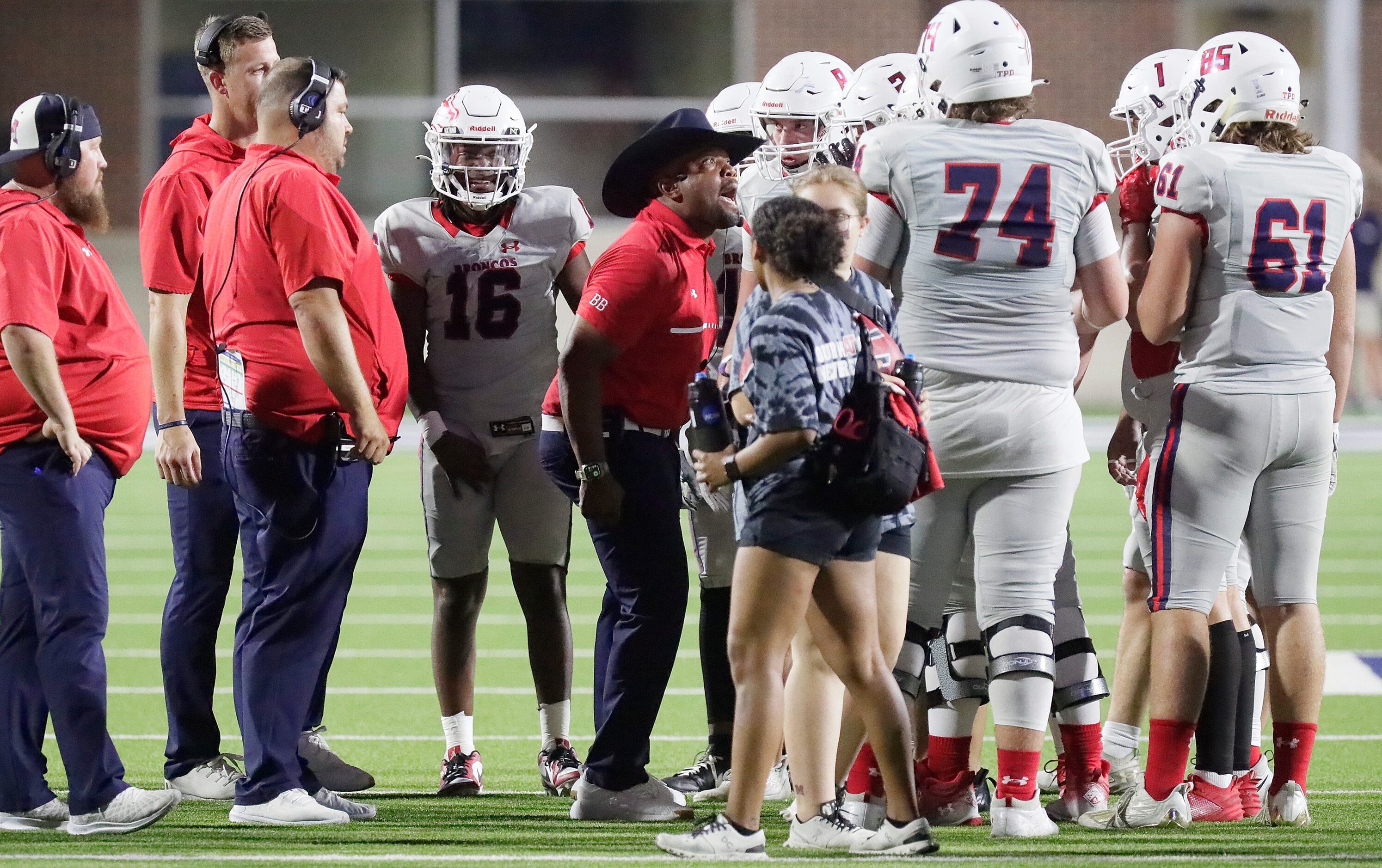 McKinney Boyd High School head coach Daniel Foster fires his team up to get a touchdown...