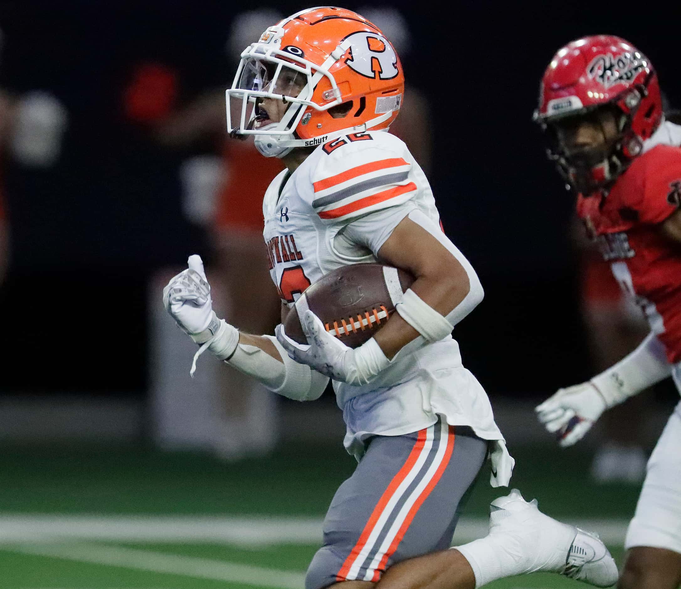 Rockwall High School running back Parker Williams (22) carries the football to the end zone...