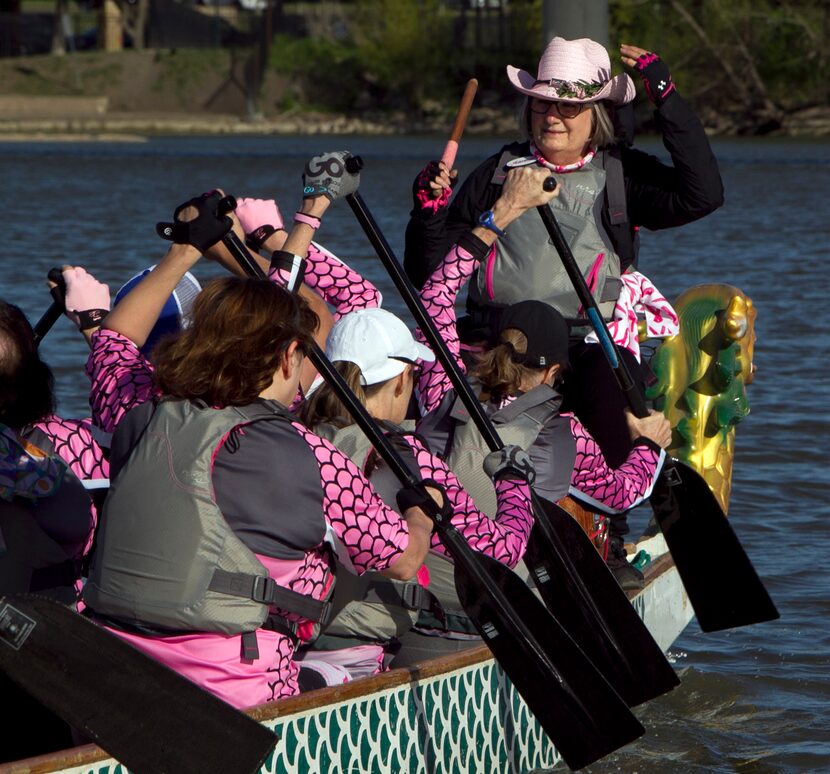 Drummer Camille Berry keeps a steady beat to help team members time their rowing motions.