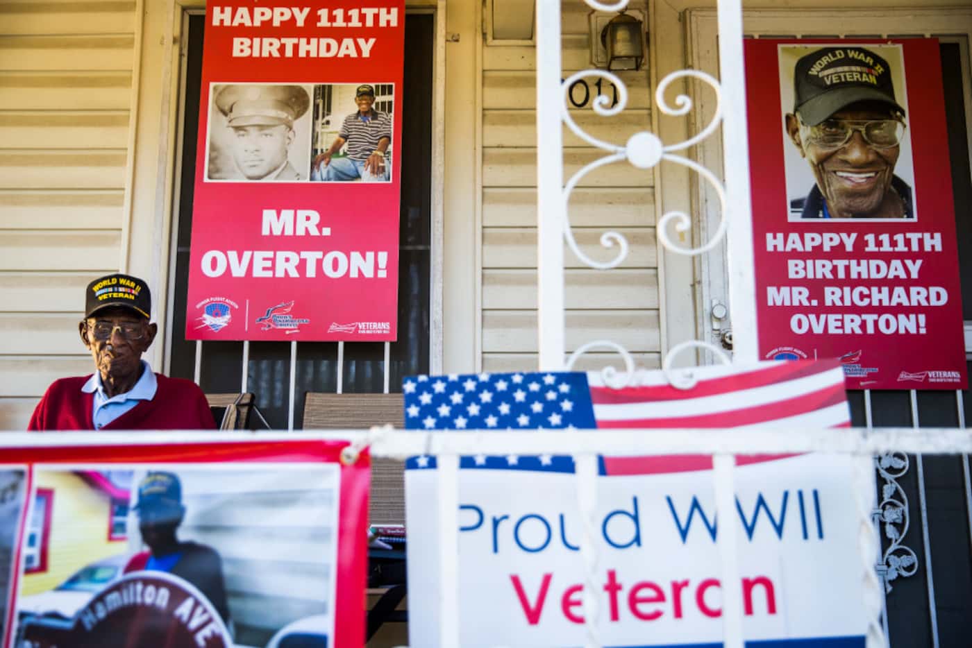 Richard Overton smoked a cigar on his Austin front porch in 2017 among signs that were...