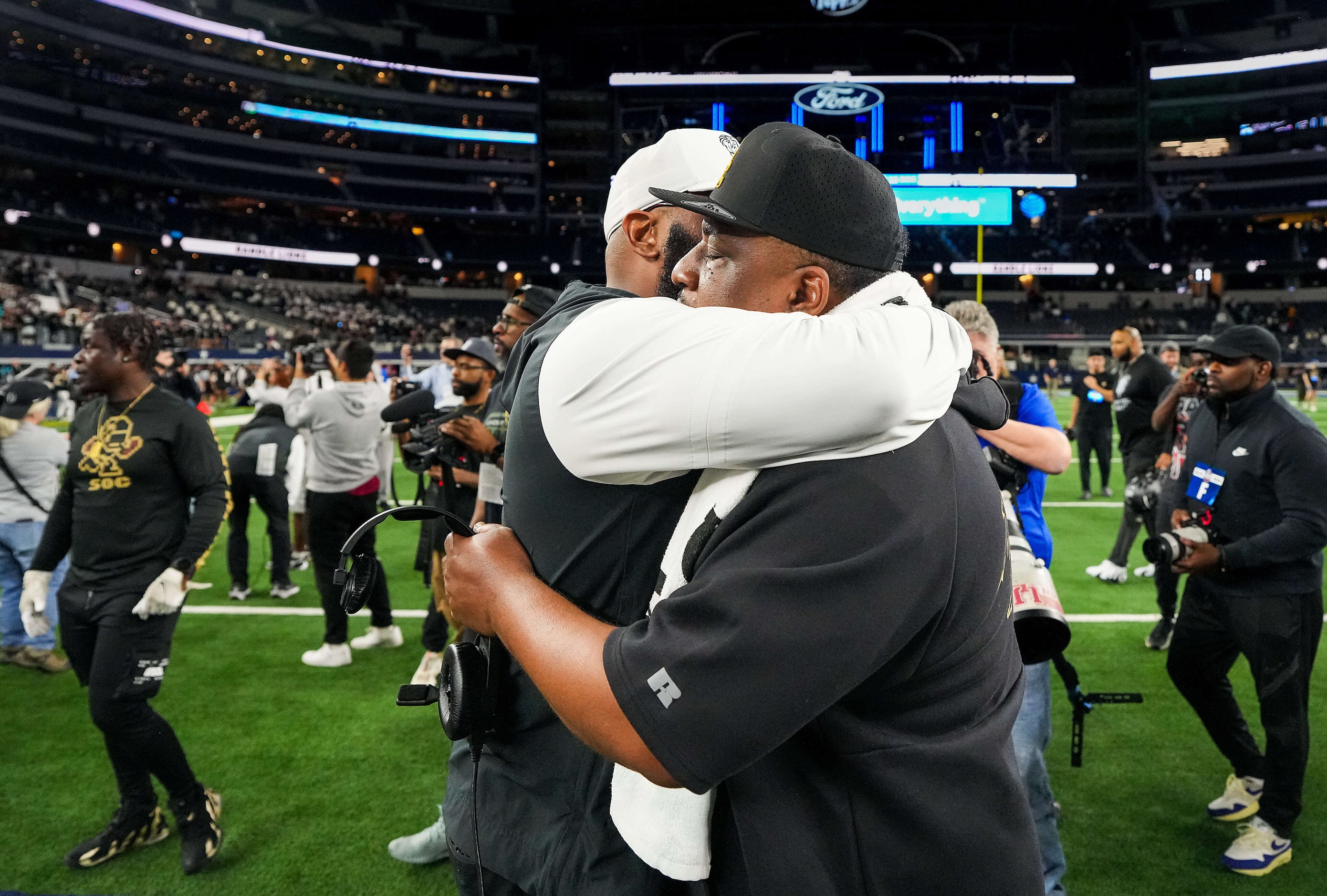 South Oak Cliff head coach Jason Todd (facing) hugs Richmond Randle head coach Brian Randle...