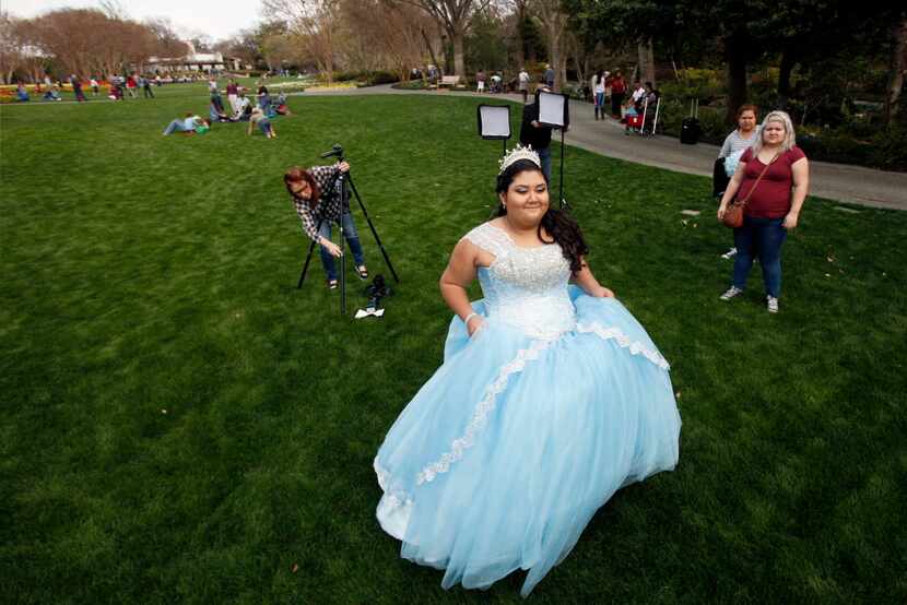 Alexandra Villalpando, 14, wearing her quinceaera   dress, walks to be photographed for her...