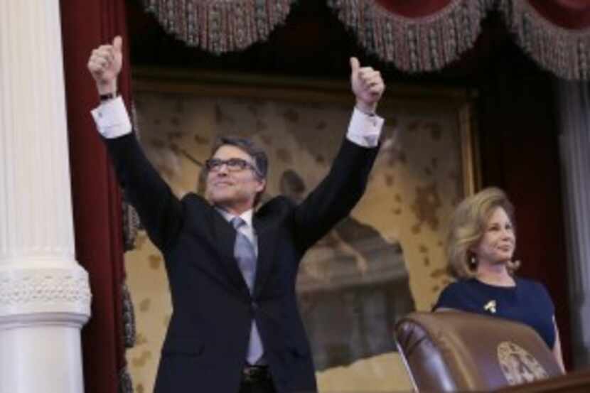  Gov. Rick Perry acknowledged applause next to wife Anita before giving a farewell speech to...