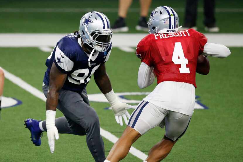 Dallas Cowboys defensive end DeMarcus Lawrence (90) pressures Dallas Cowboys quarterback Dak...