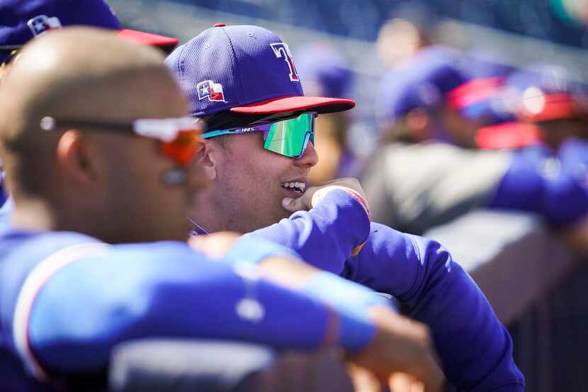Texas Rangers outfielder Steele Walker watches from the dugout during a spring training game...