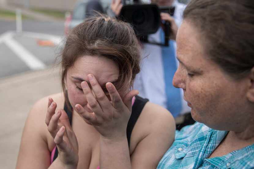 Angel Velazquez  is overcome with emotion as she speaks to local news media about how the...