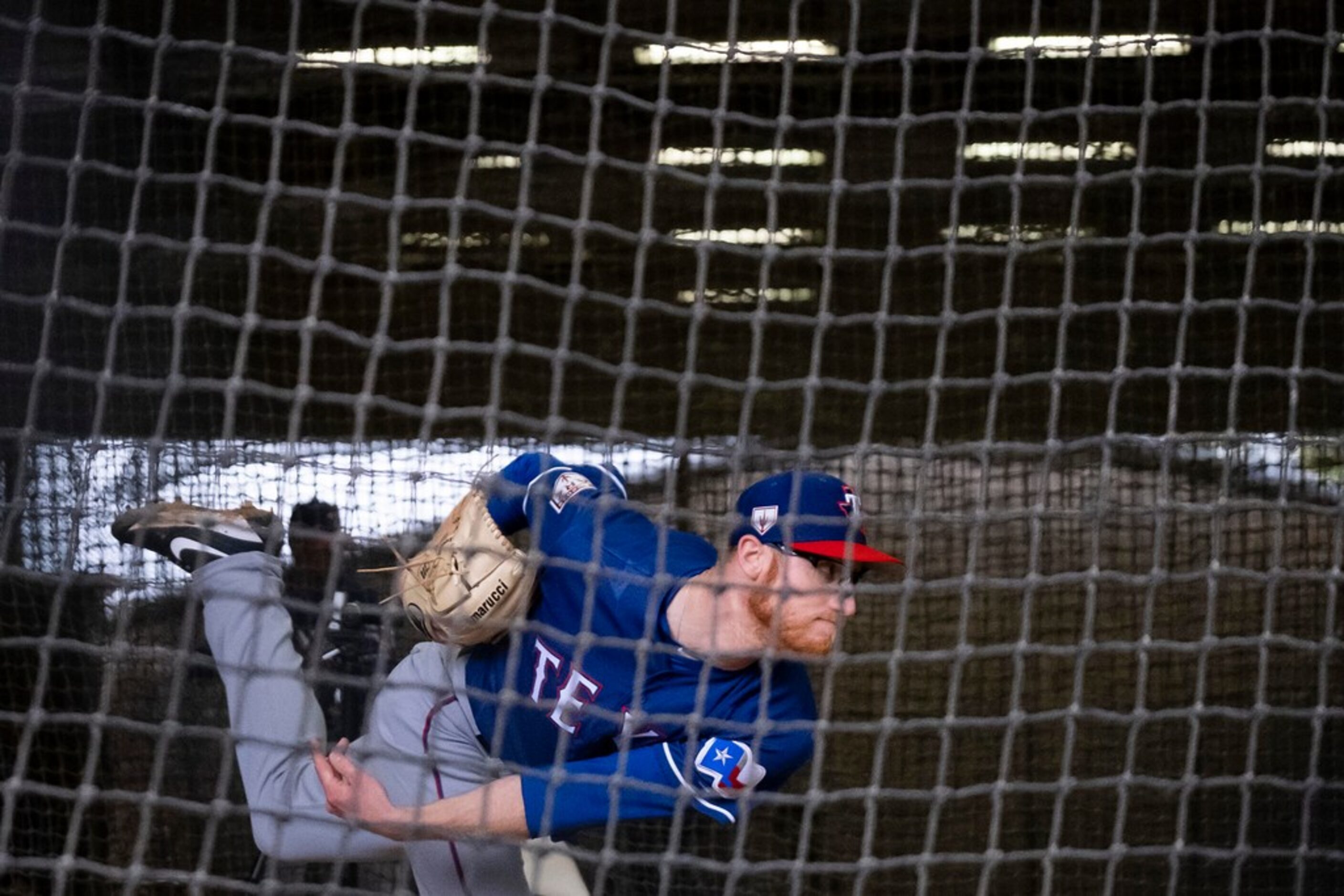 Texas Rangers pitcher Brady Feigl throws live batting practice inside the batting cages...