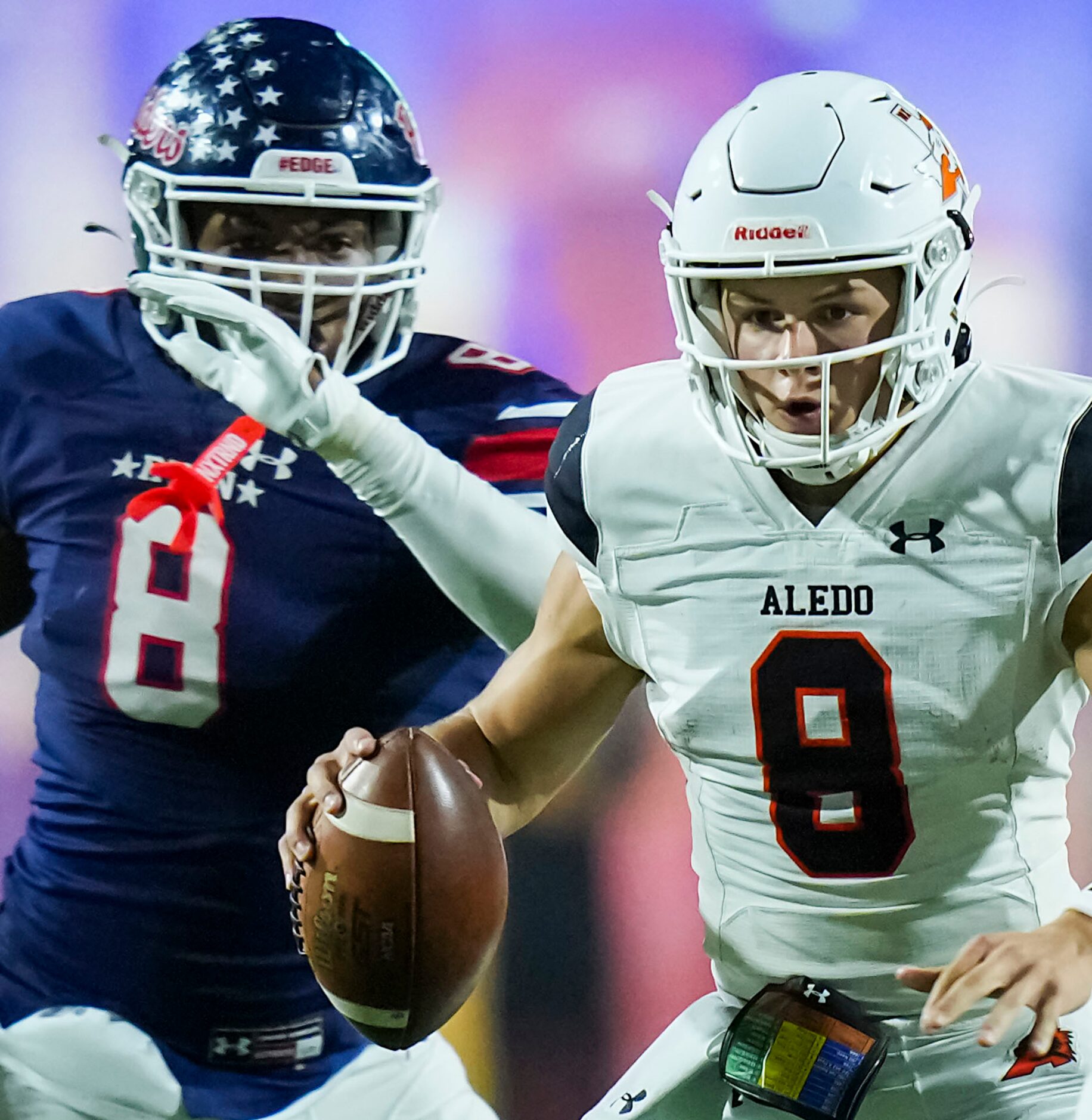 Aledo quarterback Hauss Hejny scrambles away from Denton Ryan defensive lineman Kyler...