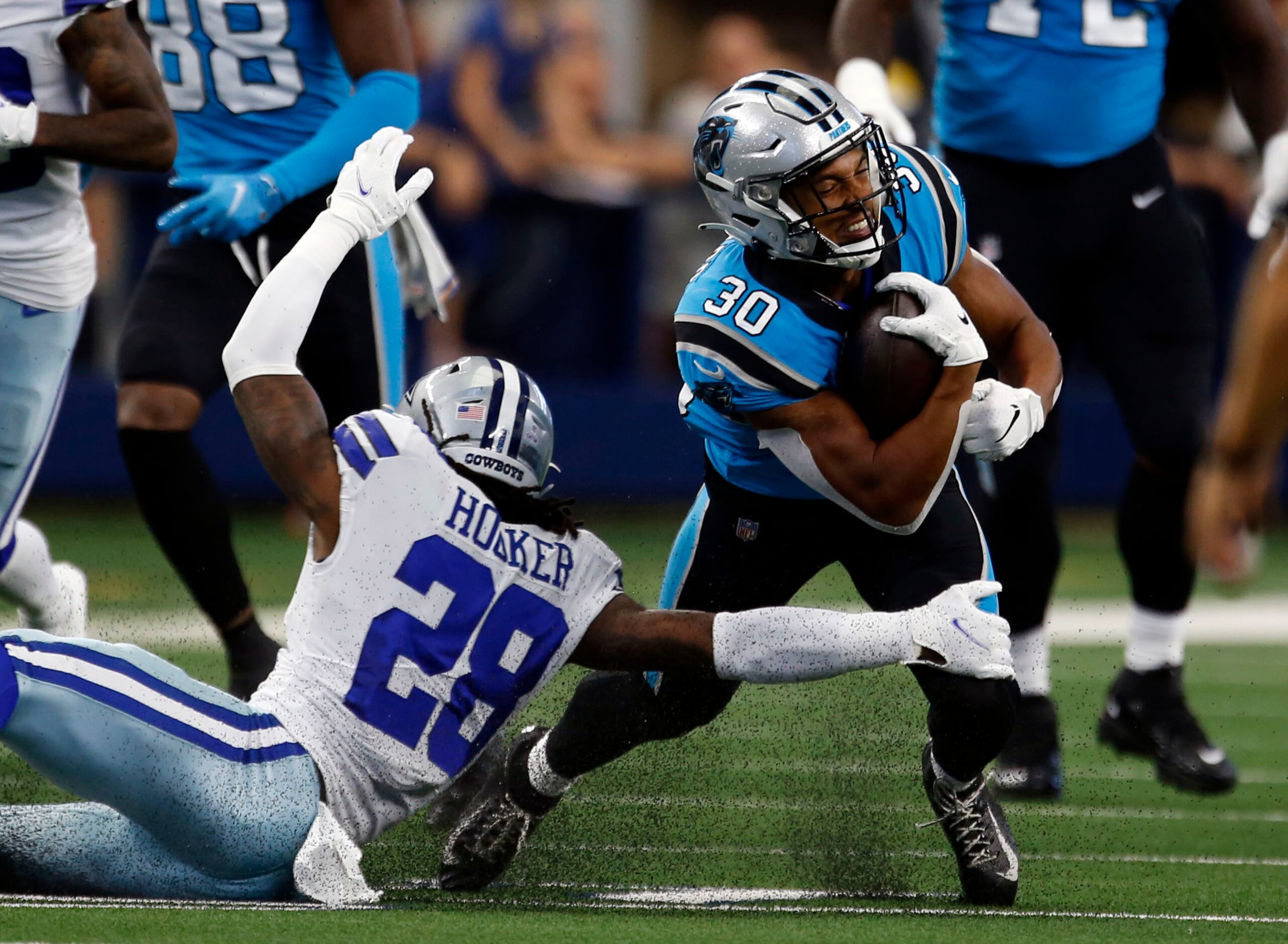 Carolina Panthers running back Chuba Hubbard (30) is rounded up by Dallas Cowboys free...