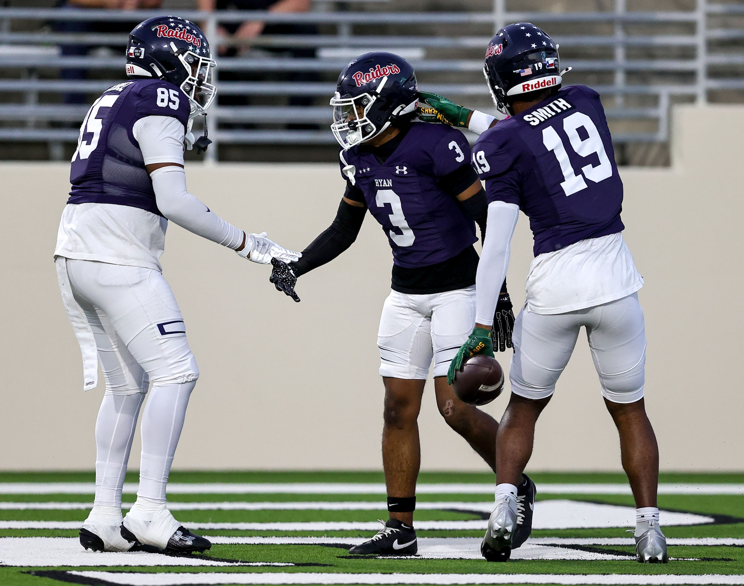 Denton Ryan wide receiver Lorenzo Hill (3) celebrates with wide receiver Raymond Smith (19)...