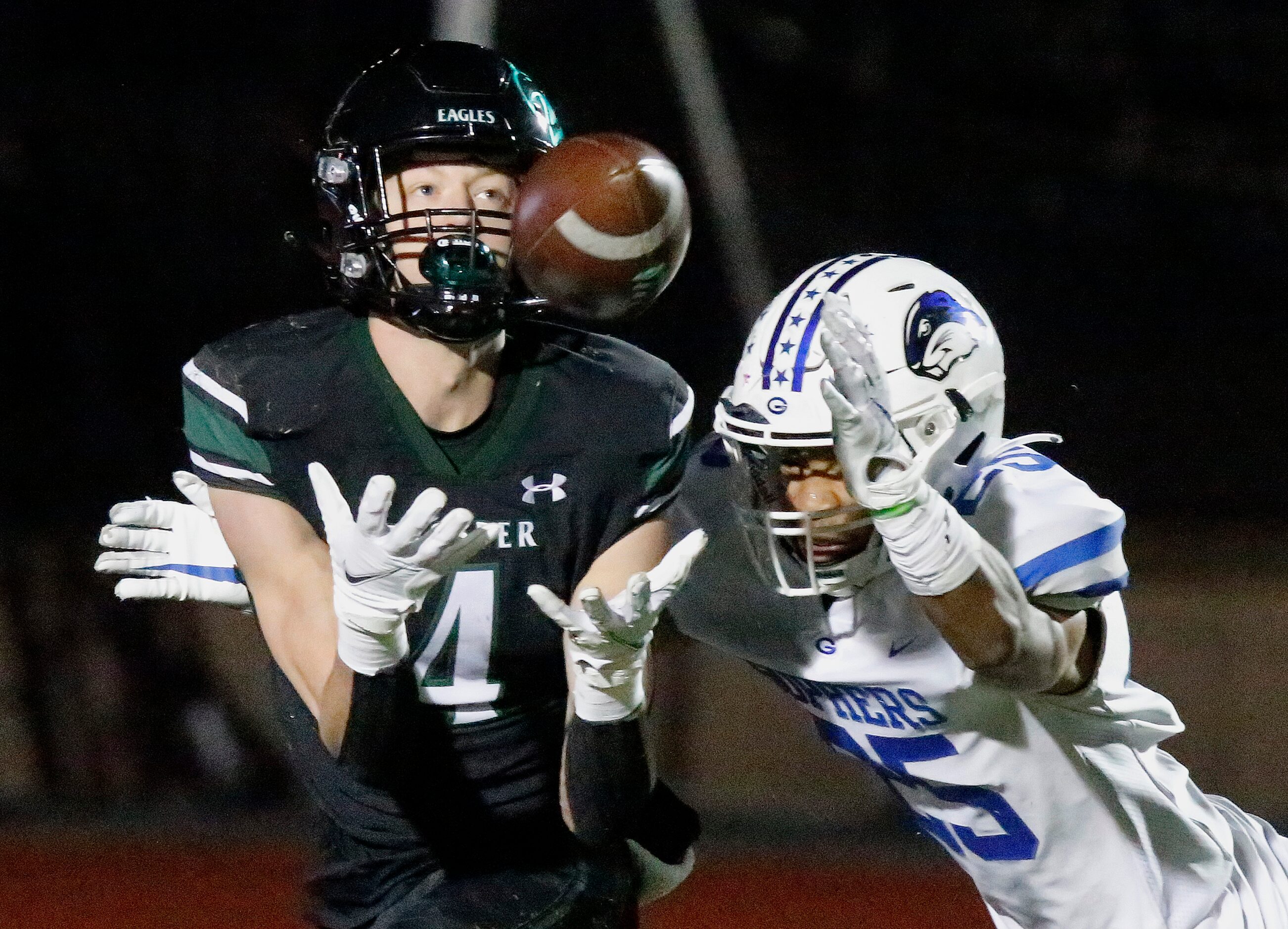 Prosper High School wide receiver Houston Hawkins (4) catches a touchdown pass as Grand...