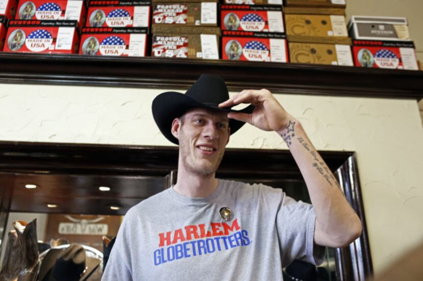 Paul "Tiny" Sturgess tries on a cowboy hat at WIld Bill's Western Store in Dallas before the...