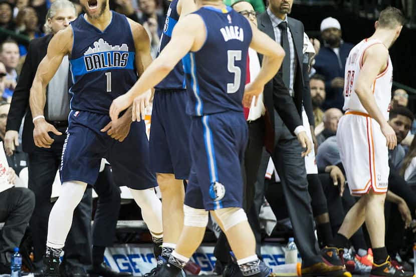 Dallas Mavericks guard Justin Anderson (1) celebrates with forward Dirk Nowitzki (41) after...