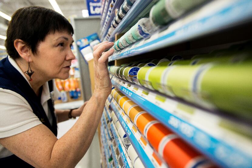 A Walmart associate inspects the placement of threads in the sewing department in...