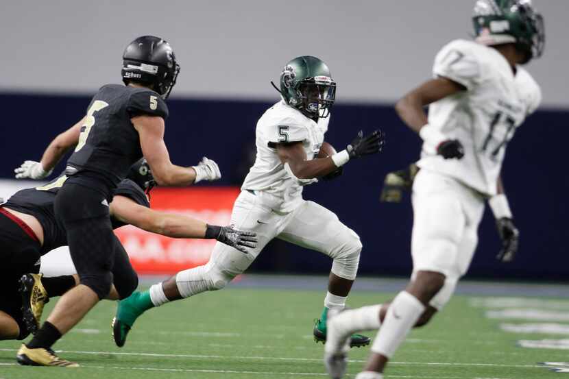 Kennedale running back Jaden Knowles (5) races out of the backfield as he is pursued...