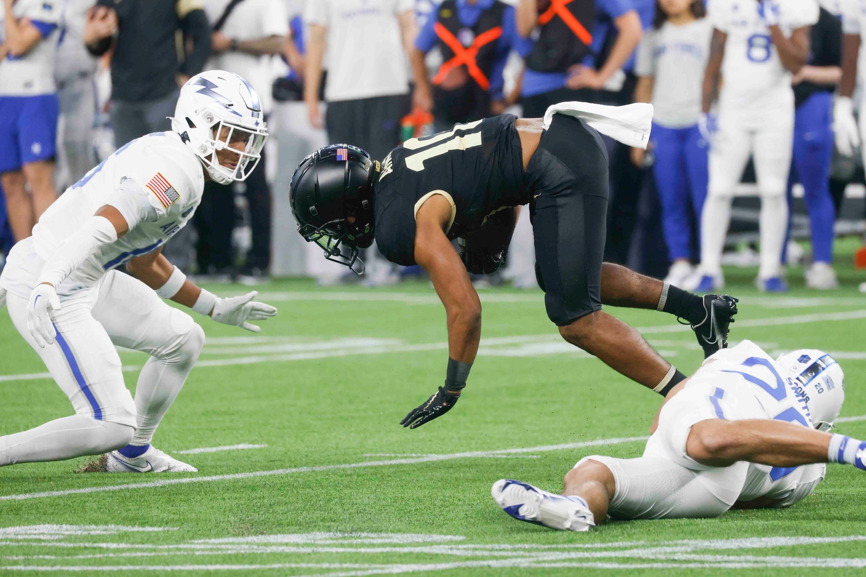 Army defensive back Cameron Jones (10), center, gets tackled by  Air Force linebacker Jake...